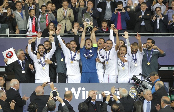 Real Madrid players lift the Champion League trophy, at the end of the Champions League final soccer match between Atletico Madrid and Real Madrid, at the Luz stadium, in Lisbon, Portugal, Saturday, May 24, 2014. (AP Photo/Daniel Ochoa de Olza)
