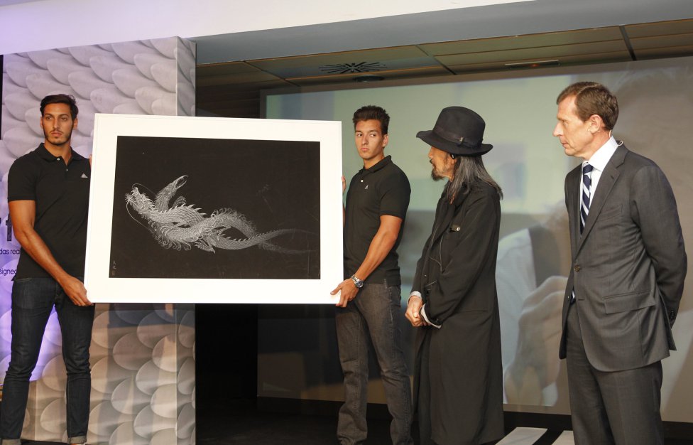 Real Madrid fans react after their team won as they watch the Champions League final soccer match between Real Madrid and Atletico Madrid, taking place in Portugal, on a giant screen at the Santiago Bernabeu stadium in Madrid, Spain, Saturday, May 24, 2014. (AP Photo/Paul White)