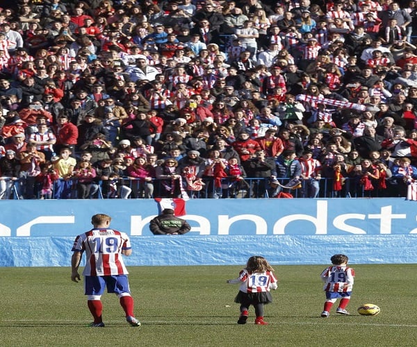 Real Madrid supporters gesture, prior to the Champions League final soccer match between Atletico Madrid and Real Madrid in downtown Lisbon, Portugal, Saturday, May 24, 2014. (AP Photo/Andres Kudacki)