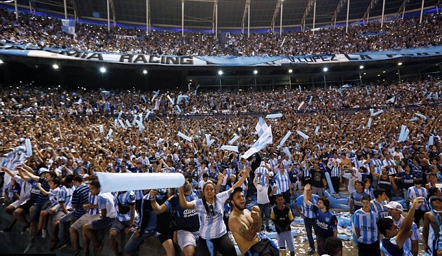 Real Madrid fans celebrate a late equaliser as the watch the Champions League final soccer match between Real Madrid and Atletico Madrid, taking place in Portugal, on a giant screen at the Santiago Bernabeu stadium in Madrid, Spain, Saturday, May 24, 2014