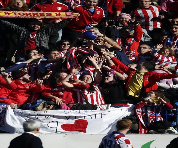 Real Madrid supporters gesture, prior to the Champions League final soccer match between Atletico Madrid and Real Madrid in downtown Lisbon, Portugal, Saturday, May 24, 2014. (AP Photo/Andres Kudacki)