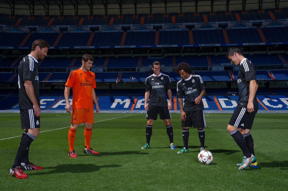Real Madrid fans celebrate a late equaliser as the watch the Champions League final soccer match between Real Madrid and Atletico Madrid, taking place in Portugal, on a giant screen at the Santiago Bernabeu stadium in Madrid, Spain, Saturday, May 24, 2014