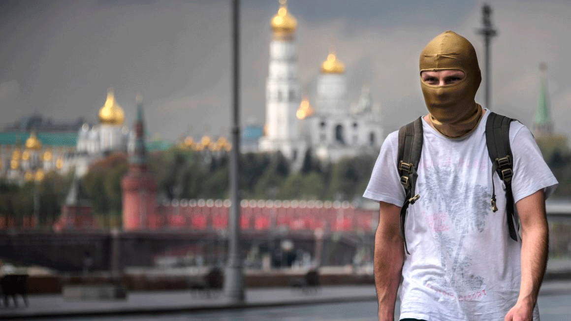 يئن اقتصاد روسيا من تراجع النفط ووطأة كورونا، وفي الصورة رجل يرتدي قناعاً يسير في موسكو، 6 مايو 2020