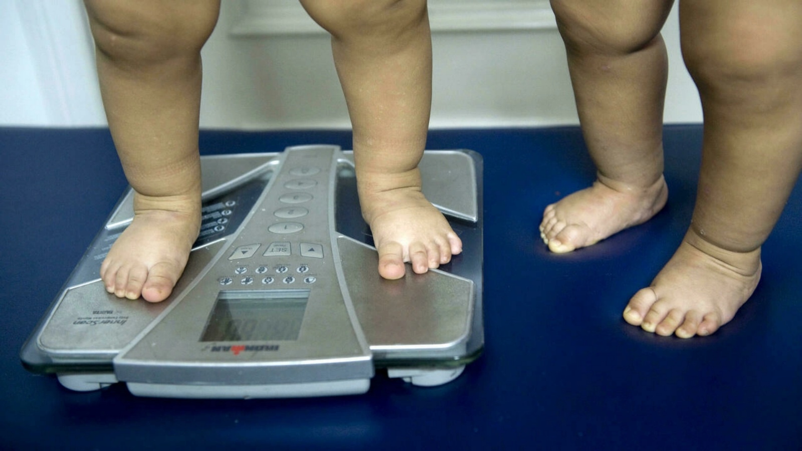 طفل يقيس وزنه حيث يظهر ارتفاع مستويات البدانة في أوساط هذه الفئة العمرية.