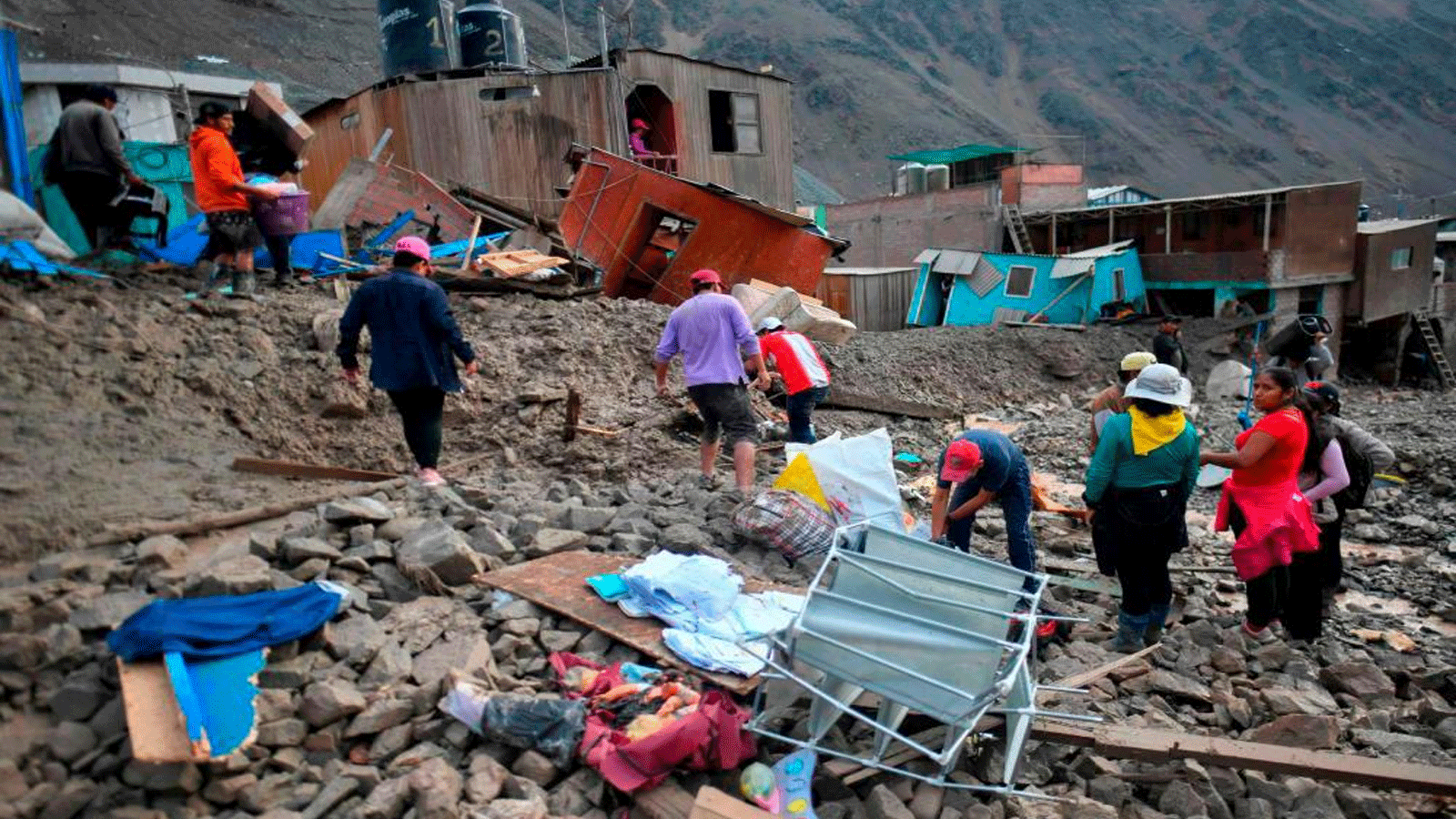 سكان قرية كامانا المعزولة، على بعد 840 كيلومترًا جنوب ليما، يسيرون بين الحطام المتبقي بعد الانهيار الأرضي في بيرو في 6 فبراير\ شباط 2023 