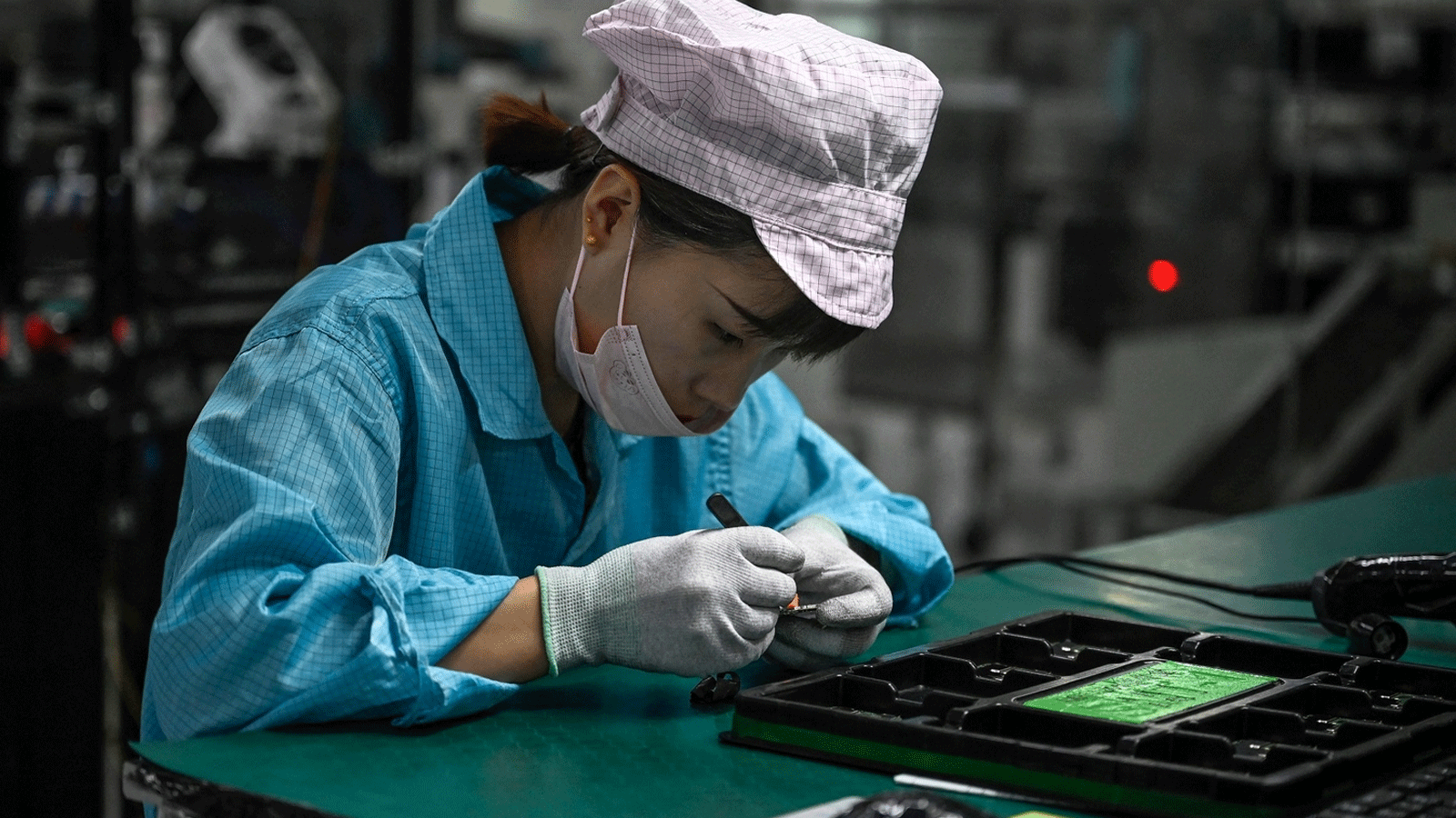 موظفة تعمل على خط إنتاج الهواتف الذكية في مصنع OPPO في دونغقوان بمقاطعة قوانغدونغ