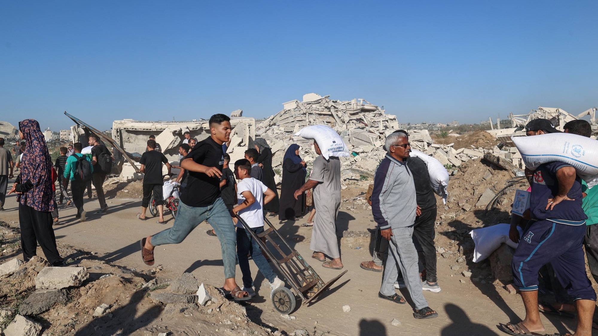 فلسطيني يهرع للحصول على مساعدات غذائية في دير البلح وسط قطاع غزة