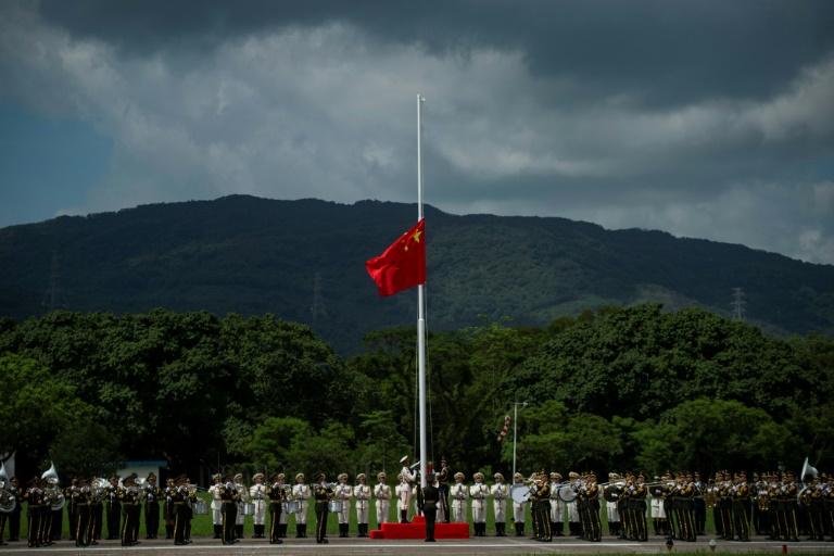 جنود من جيش التحرير الشعبي الصيني يرفعون علم بلادهم خلال احتفال في قاعدة جوية في هونغ كونغ
