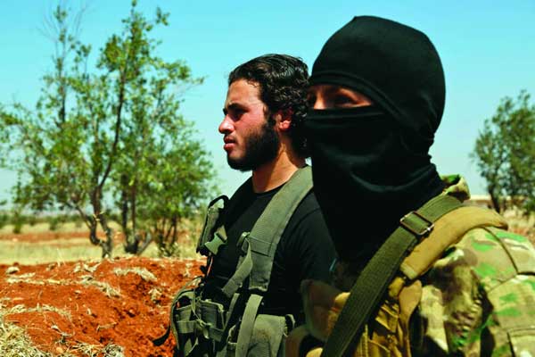 مسلحان سوريان في كفر زيتا في إطار الاستعدادات لمعركة إدلب (أ ف ب)