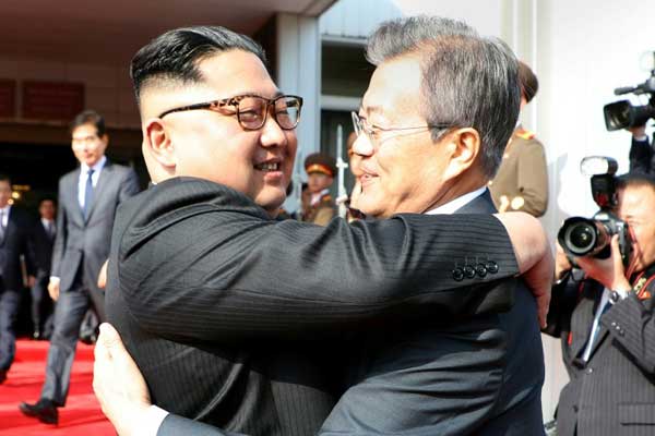 صورة التقطت في 26 مايو 2018 يظهر فيها الرئيس الكوري الجنوبي مون جاي إن والزعيم الكوري الشمالي كيم جونغ أون يتعانقان بعد قمتهما الثانية في الشمال في قرية بانمونجوم في المنطقة المنزوعة السلاح