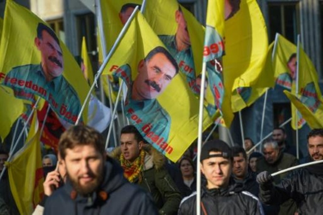 متظاهرون يرفعون أعلاما تحمل صورة الزعيم الكردي عبدالله أوجلان