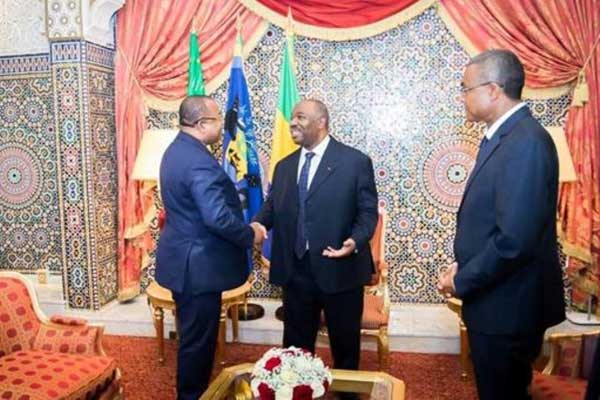 صورة وزعتها الرئاسة الغابونية في 25 فبراير 2019 تظهر الرئيس علي بونغو (وسط الصورة) مستقبلًا رئيس الوزراء جوليان باكيلي (يسار)