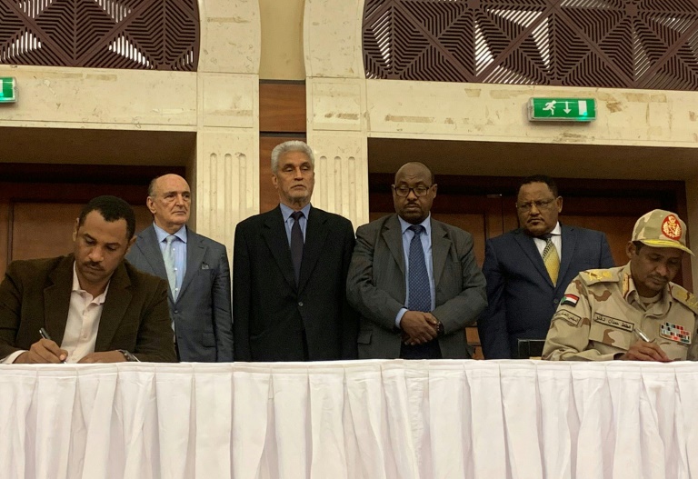 نائب رئيس المجلس العسكري الحاكم محمد حمدان دقلو (يمين) وأحمد الربيع ممثل المحتجين يوقعان بالاحرف الاولى وثيقة الاتفاق السياسي في الخرطوم في 17 يوليو 2019.