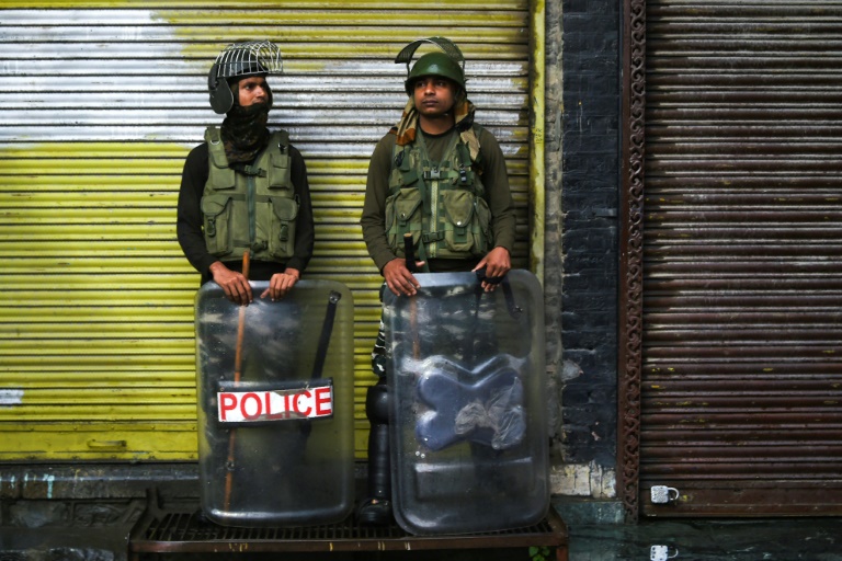 عنصران أمنيان في نوبة حراسة اثناء إغلاق أمني في سريناغار في كشمير في 14 آب/اغسطس 2019. 