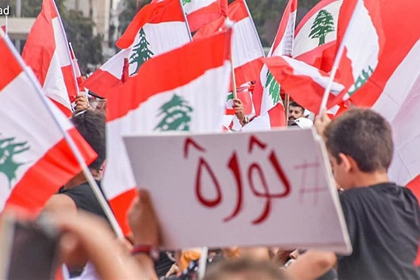 متظاهرون يحملون علم لبنان