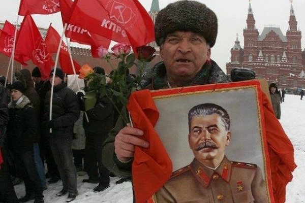 روسي يحمل صورة ستالين