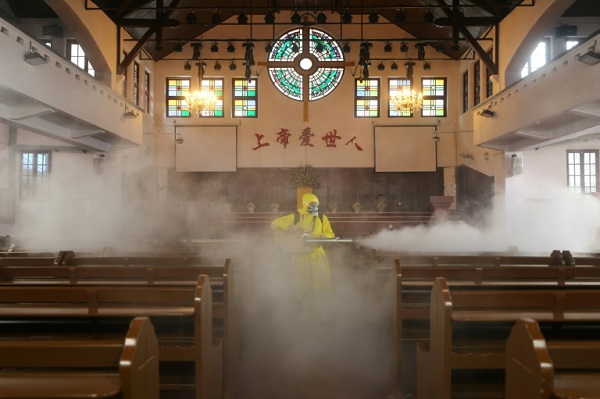 عامل يرش مواد تعقيم في كنيسة في مدينة ووهان في الصين في 6 مارس 2020