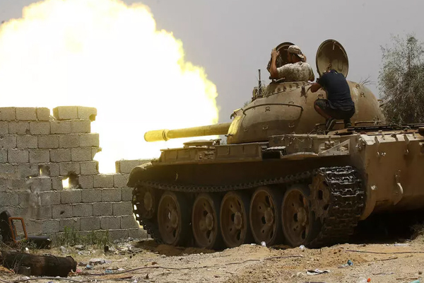 مقاتلون ليبيون موالون لحكومة الوفاق الوطني يطلقون النار من دبابة أثناء القتال ضد القوات الموالية للمشير خليفة حفتر، في جنوب العاصمة الليبية طرابلس، في 13 يونيو2019