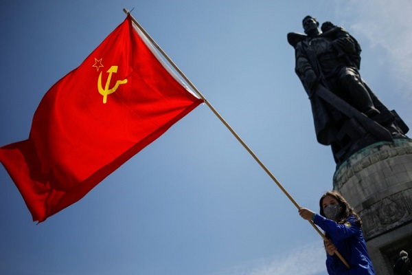 فتاة تحمل علم الاتحاد السوفياتي عند النصب التذكاري للحرب العالمية الثانية في برلين