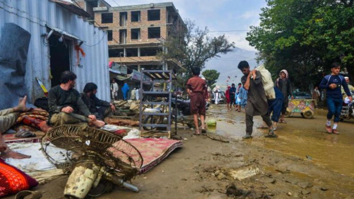 أفغان يلملمون ما بقي من منزلهم الذي جرفه الفيضان في شاريكار الأربعاء
