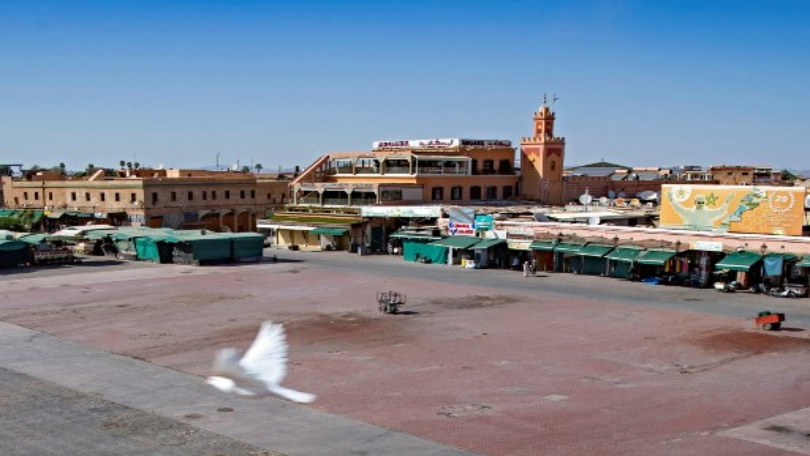 عدد قليل من الناس في أكشاك مغلقة في الغالب في ساحة جامع الفنا في مدينة مراكش المغربية في 8 سبتمبر 2020 ، وهي خالية حاليًا من الحشود المعتادة بسبب جائحة COVID-19.