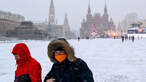 روسيان بالكمامة في الساحة الحمراء المغطاة بالثلوج الجمعة