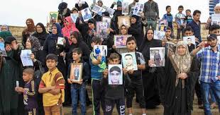 عائلات عراقية تحمل صور ابنائها المغيبين مطالبة بمعرفة مصيرهم
