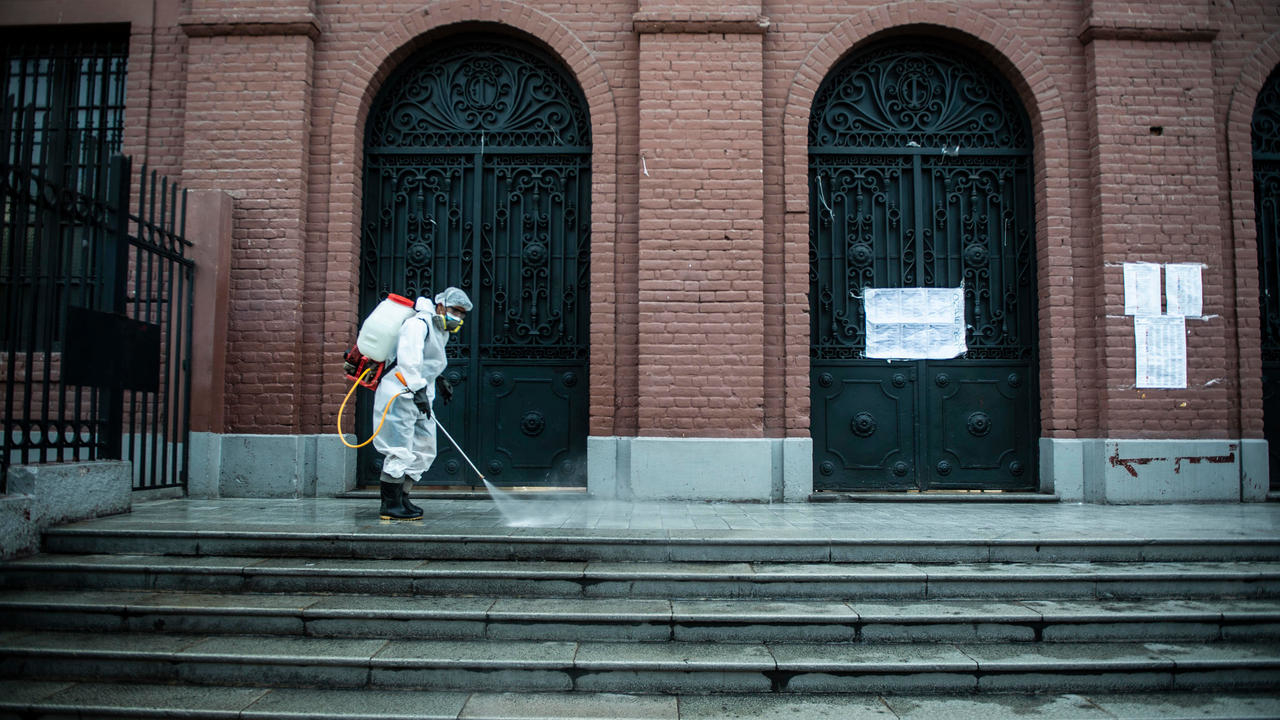موظف يقوم بتطهير محيط مركز الاقتراع في عاصمة البيرو ليما في 10 نيسان/ابريل 2021