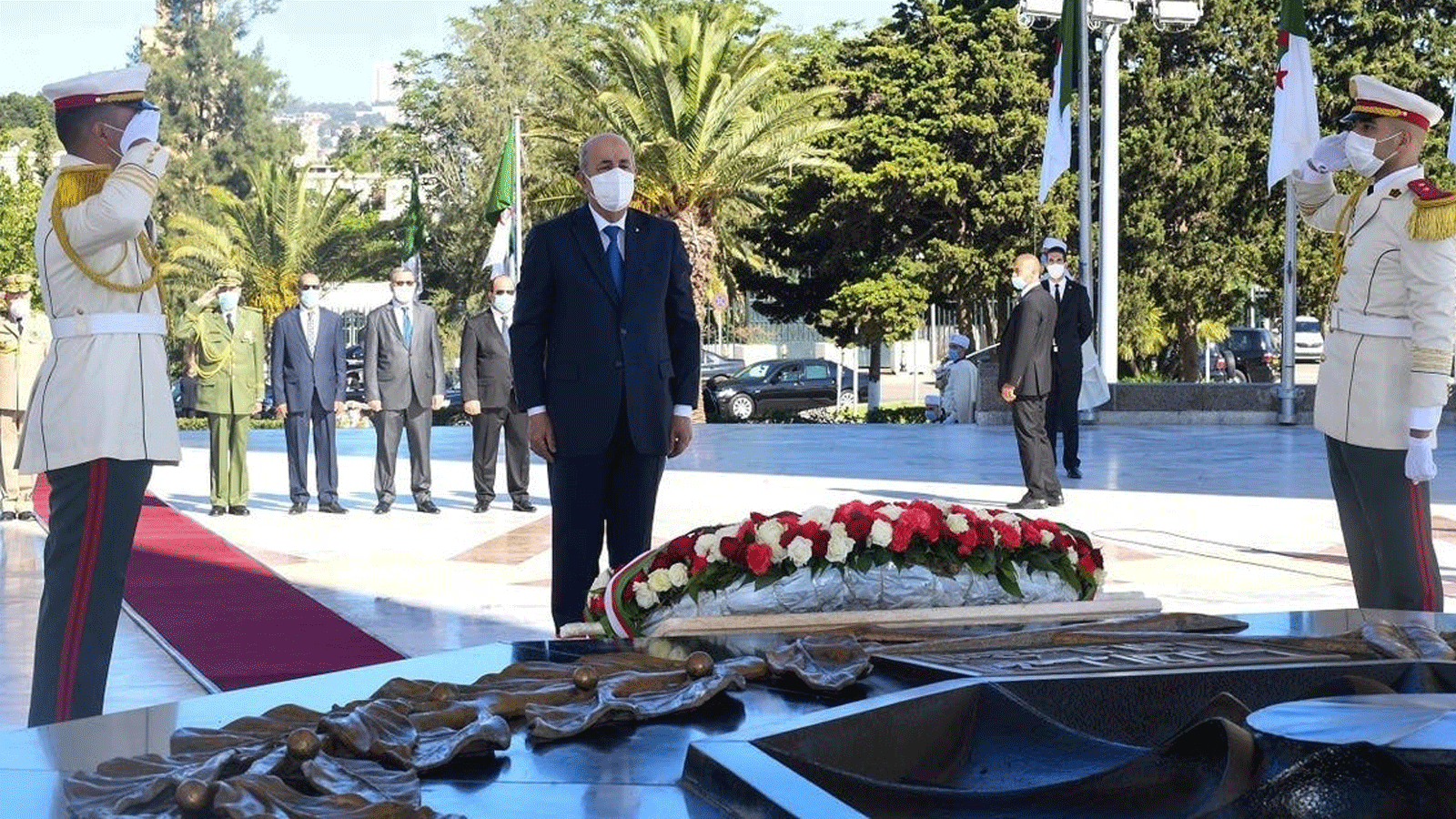الرئيس الجزائري تبون يقف دقيقة صمت خلال مراسم لإلقاء رفات 24 من المقاومين العائدين من باريس. في العاصمة الجزائر بتاريخ 5 تموز/ يوليو 2020.