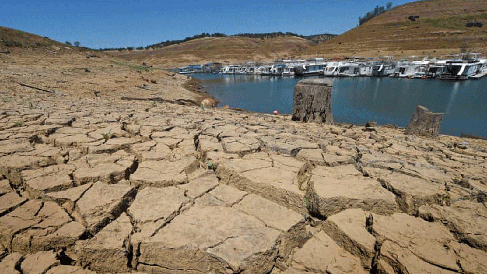 صورة تُظهر الطين الجاف وبقايا المرسى في خزان بحيرة ميلونز الجديدة في كاليفورنيا