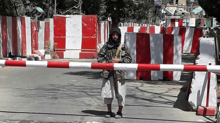 مقاتل من طالبان أمام أحد مقرات الشرطة بعد استيلاء الحركة على مدينة غوزني في 11 آب/أغسطس 2021