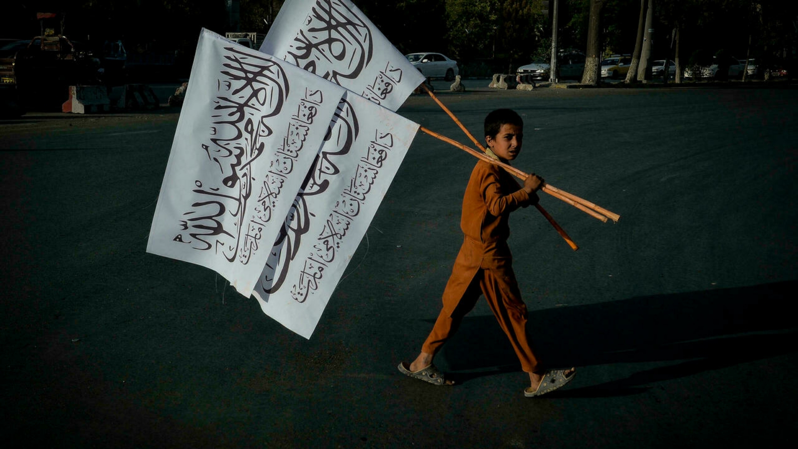 صبي يحمل أعلام طالبان لبيعها في العاصمة الأفغانية كابول.
