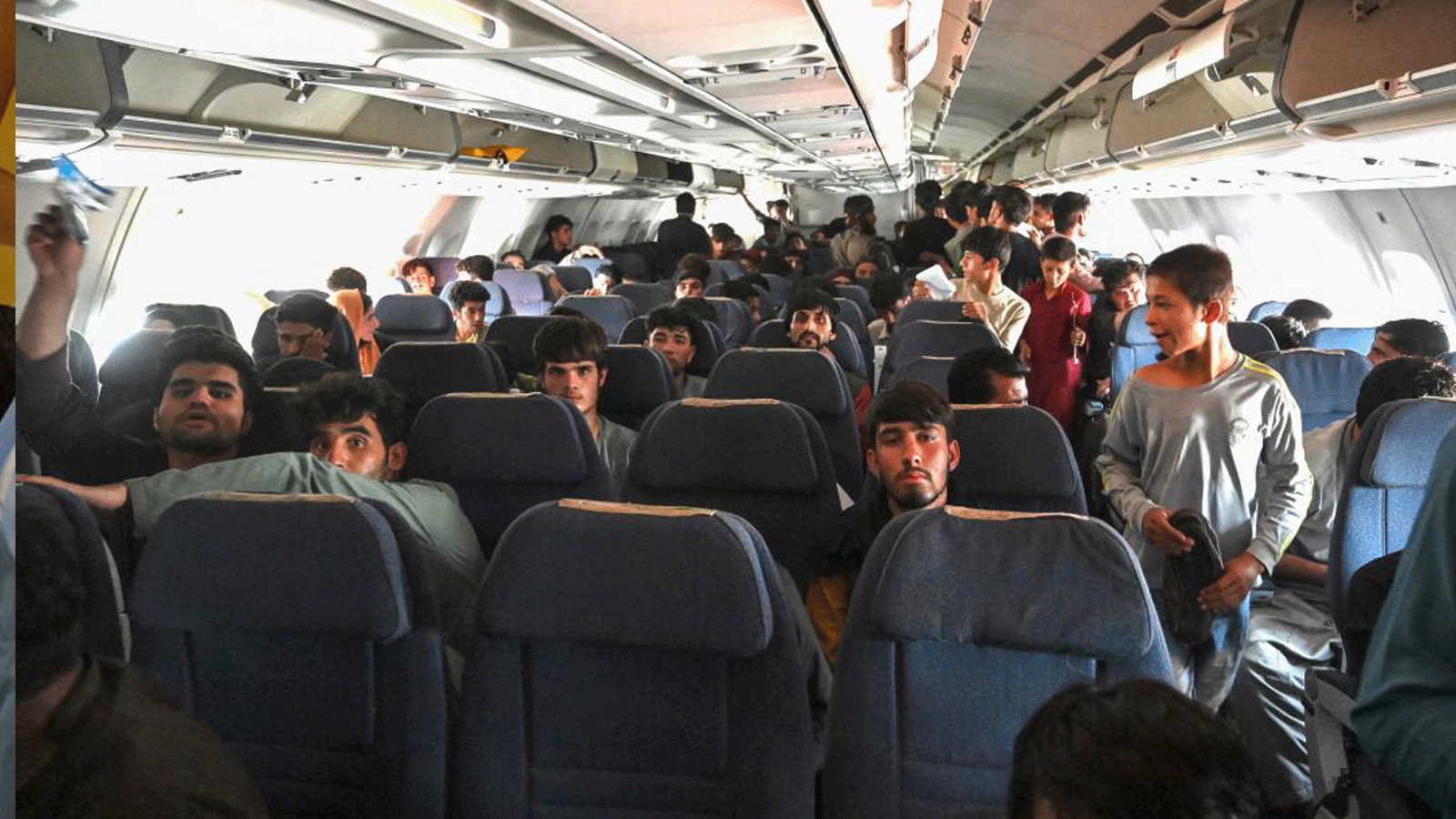 ركاب أفغان يجلسون داخل طائرة أثناء انتظارهم مغادرة مطار كابول.