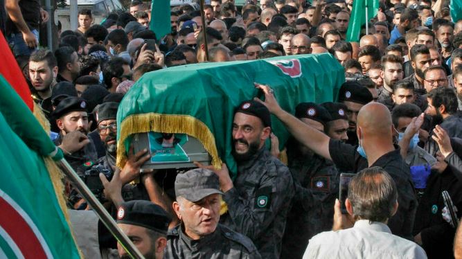 عناصر من حركة أمل الشيعية يشيعون مسلحًا قضى في مواجهات بيروت التي جرت الخميس 14 أكتوبر 2021