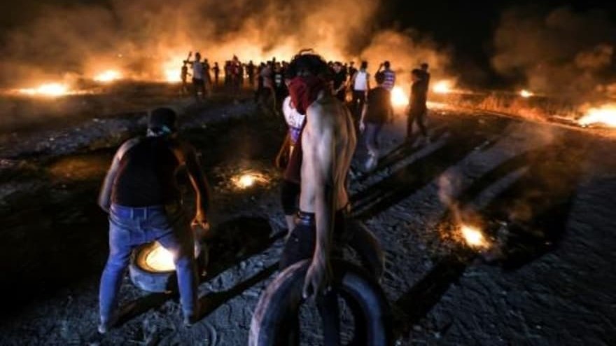 محتجون فلسطينيون يحرقون إطارات خلال تظاهرة على السياج الحدودي بين اسرائيل وقطاع غزة في شرق مدينة غزة في 28 أغسطس 2021