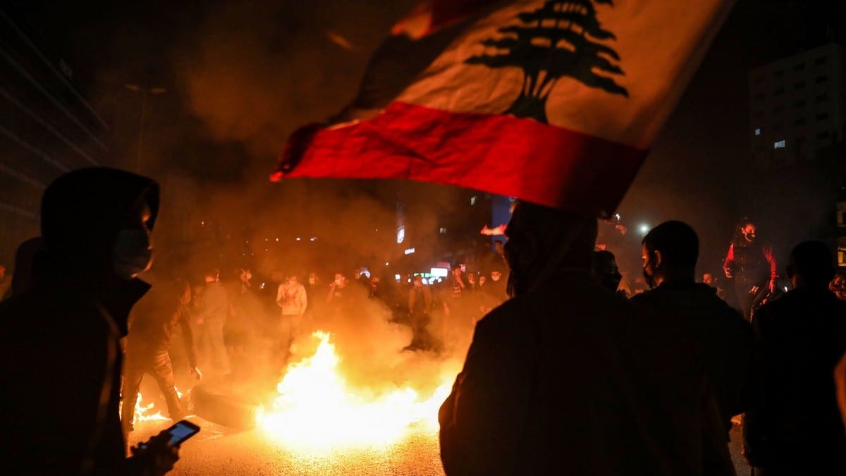 متظاهرون يلوحون بالعلم الوطني اللبناني احتجاجًا على تدهور الأوضاع الاقتصادية والاجتماعية في بيروت، لبنان في 2 مارس 2021