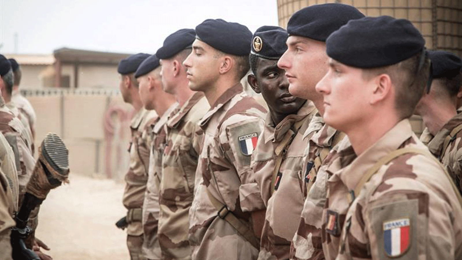 الجنود الفرنسيون يقفون في حالة من الانتباه أثناء انتظارهم مراسم تسليم قاعدة برخان العسكرية للجيش المالي في تمبكتو، في 14 كانون الأول/ ديسمبر 2021.