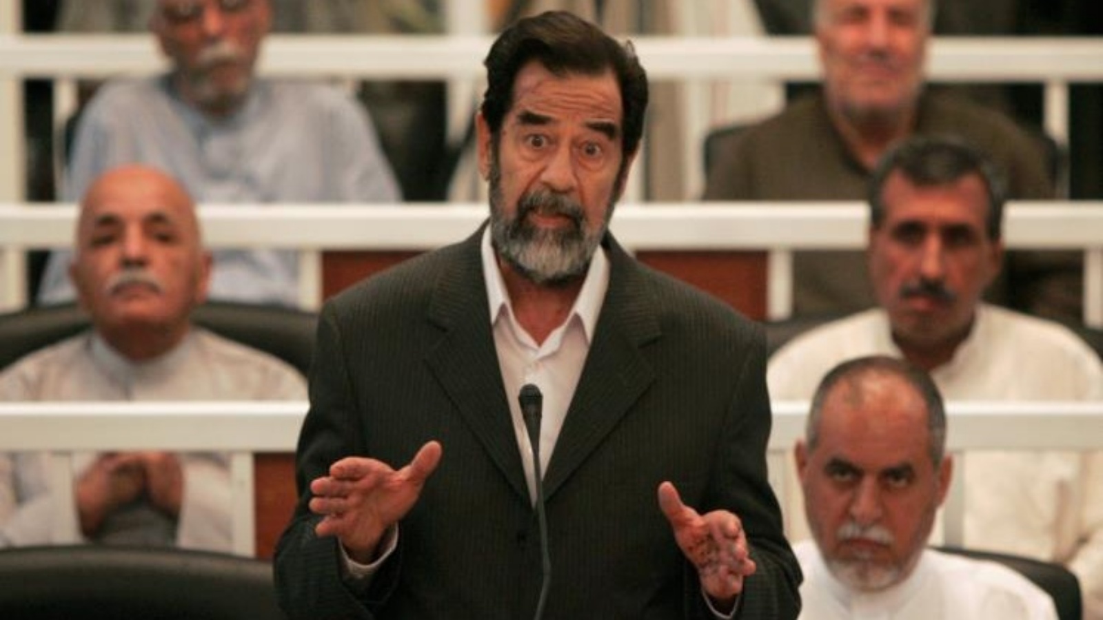 صدام حسين يتحدث خلال إحدى جلسات محاكمته (تويتر)