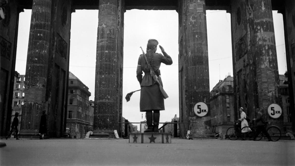 جندية من الجيش الأحمر السوفياتي تضبط حركة المرور أمام بوابة براندنبورغ في يوليو 1945 في برلين.