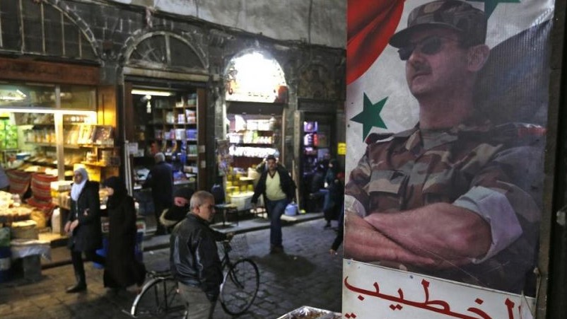 ملصق لرئيس النظام السوري في أحد أحياء العاصمة السورية دمشق