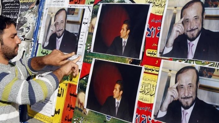 علوي يلصق صور رفعت الأسد ونجله ريبال على جدار في طرابلس شمال لبنان في 6 ديسمبر 2007