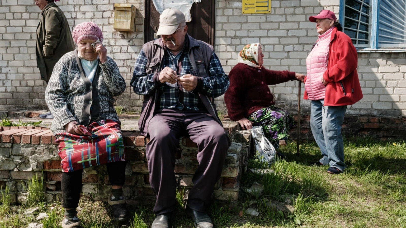 مسنون ينتظرون الحصول على معاشاتهم التقاعدية قرب شاجنة للبريد تمكنت من الاقتراب من خط الجبهة في ماياكي في شرق أوكرانيا في السادس من مايو 2022