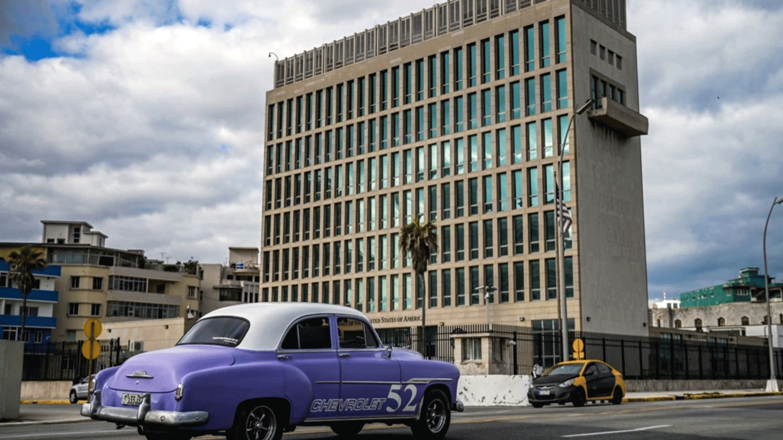 سيارة أميركية قديمة تمرّ أمام السفارة الأميركية في هافانا، كوبا في 3 أيار\ مايو 2022، حيث استأنفت القنصلية إصدار بعض خدمات تأشيرات الهجرة التي تم تعليقها منذ عام 2017