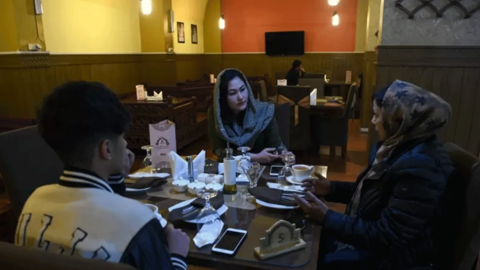 صورة أرشيفية لرجال ونساء أفغان يتحدثون أثناء تناول الشاي في مطعم في كابول. 30 كانون الثاني\يناير 2019
