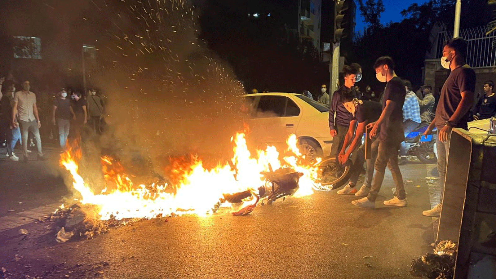 متظاهرٌ يسحب دراجة نارية محترقة خلال احتجاجات على وفاة مهسا أميني في طهران. 19 أيلول\سبتمبر 2022