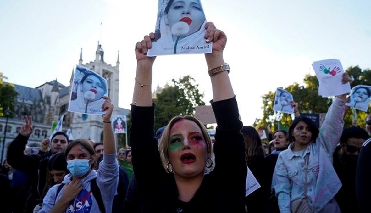 أشخاص يرددون شعارات ويحملون صور مهسا أميني خلال مظاهرة في وسط لندن