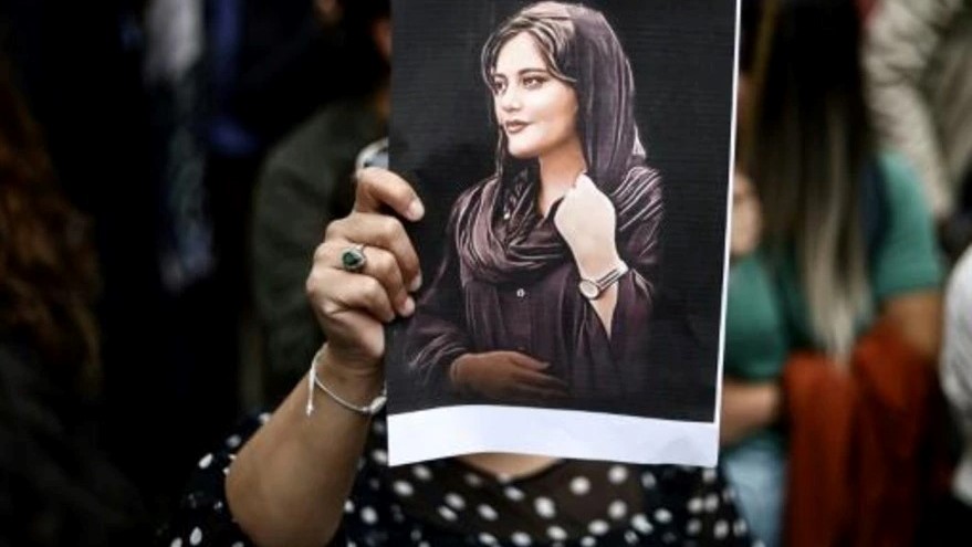  متظاهرة تحمل صورة مهسا أميني، خلال تظاهرة داعمة للحركة الاحتجاجية في إيران، في 23 سبتمبر 2022 في بروكسل