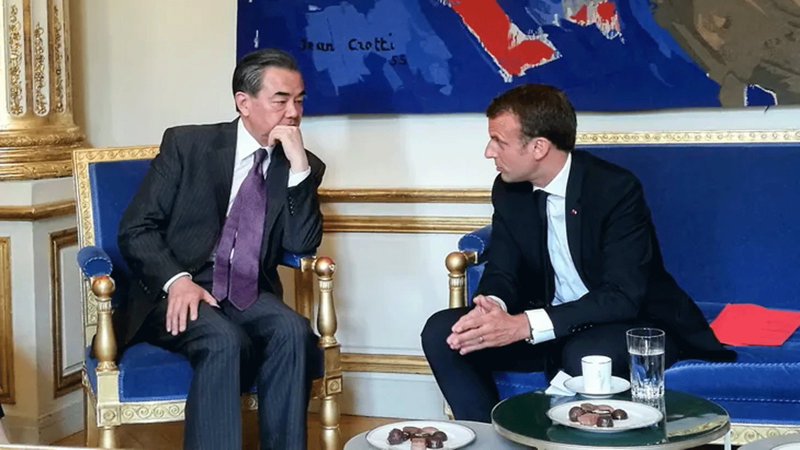 الرئيس الفرنسي إيمانويل ماكرون ووزير الخارجية الصيني وانغ يي