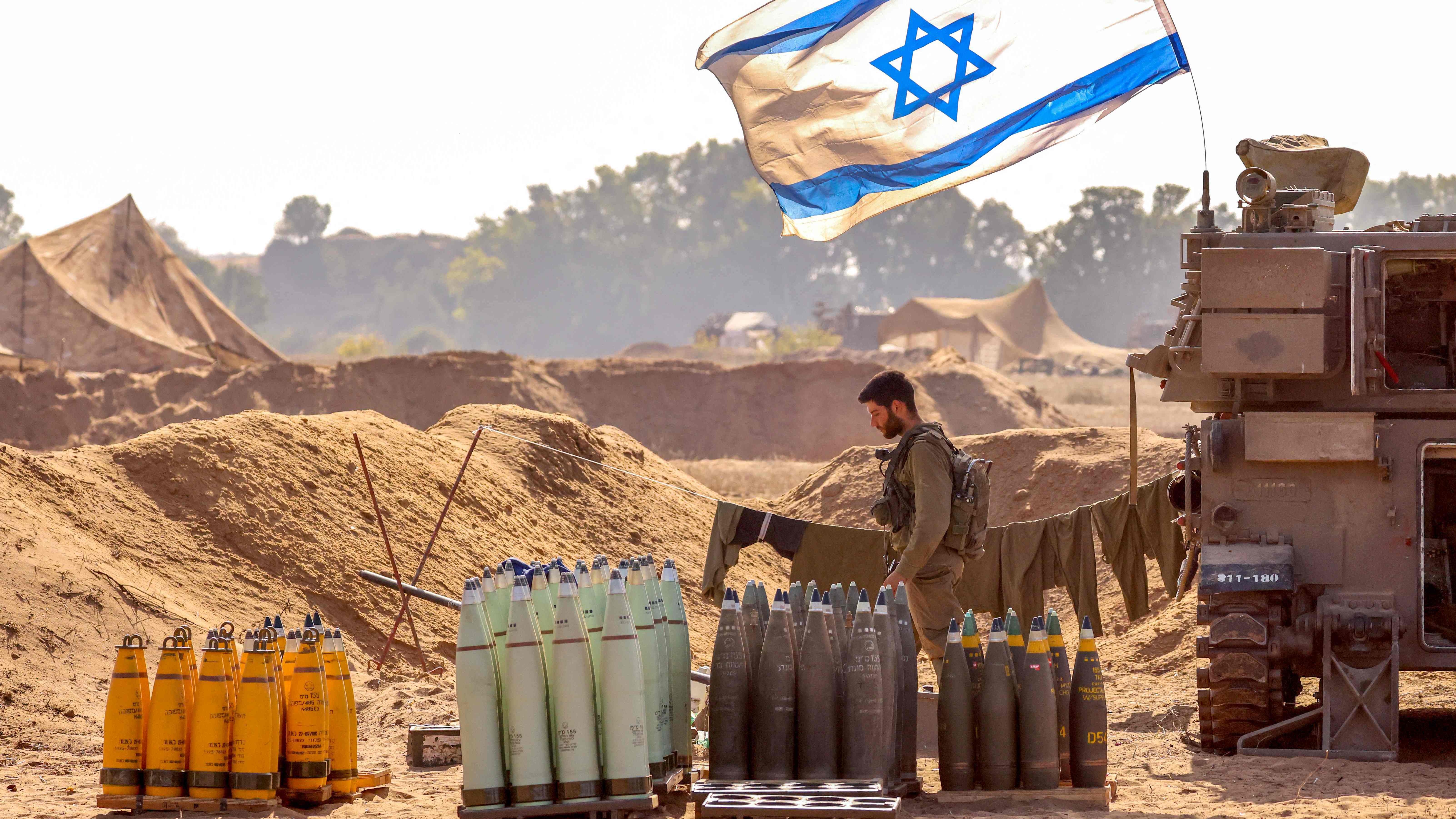 جندي إسرائيلي أمام عتاد وقذائف أميركية يحضرها لاستخدامها في الحرب في غزة