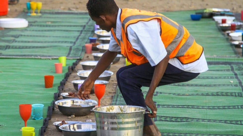 متطوع يحضر الطعان لنازحين في القضارف في الوسدان في 13 آذار/مارس 2024